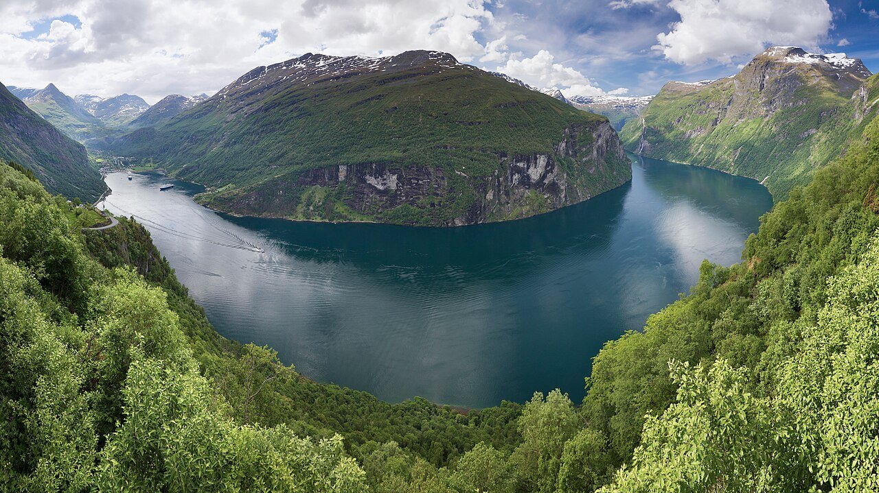 Sweeping view of the Geirangerfjord winding between green mountains
