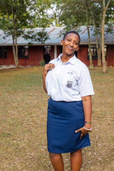 A smiling teenage girl in a school uniform